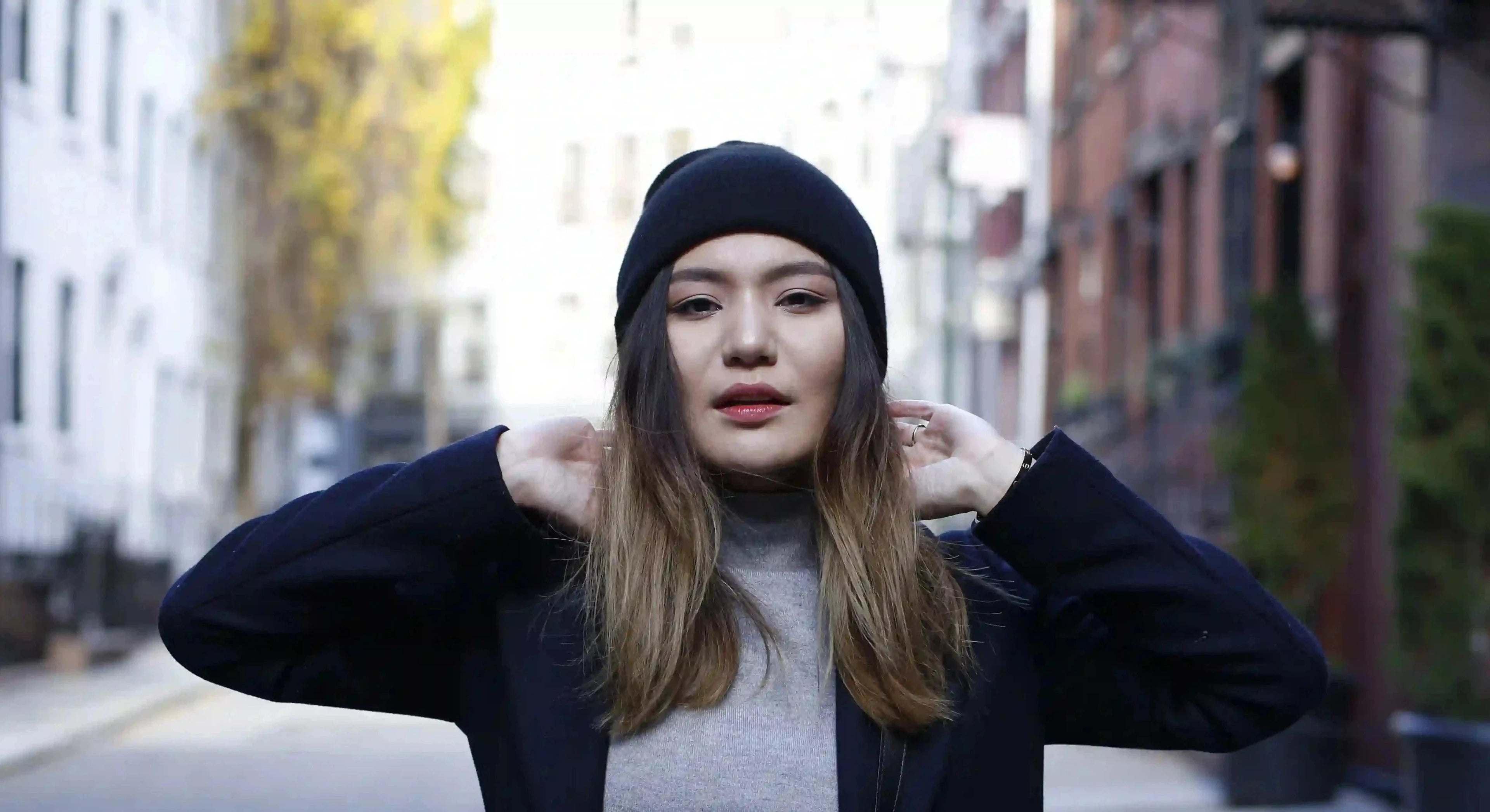 Baatar Cashmere owner wearing a luxurious cashmere beanie on a bustling New York street, showcasing timeless winter fashion with premium comfort and style